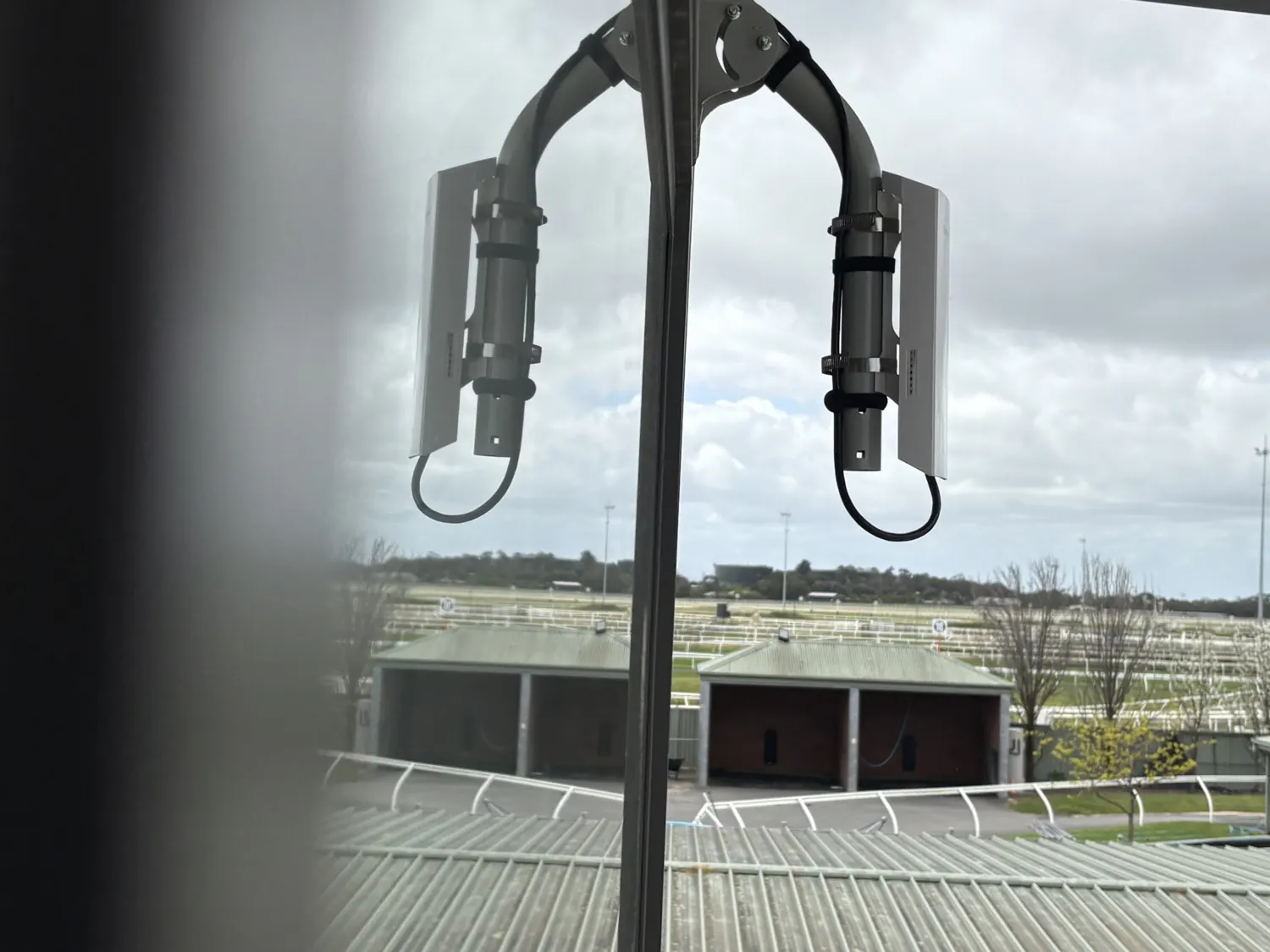 Two wireless bridge units aimed from the office across the Cranbourne stable complex.