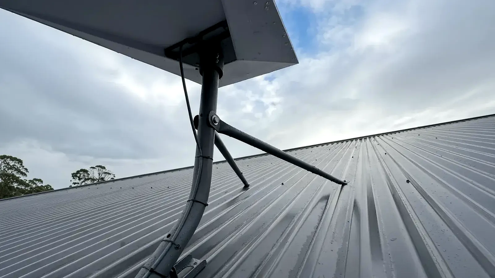 Starlink Standard dish on a tripod on a metal roof in Cranbourne West.