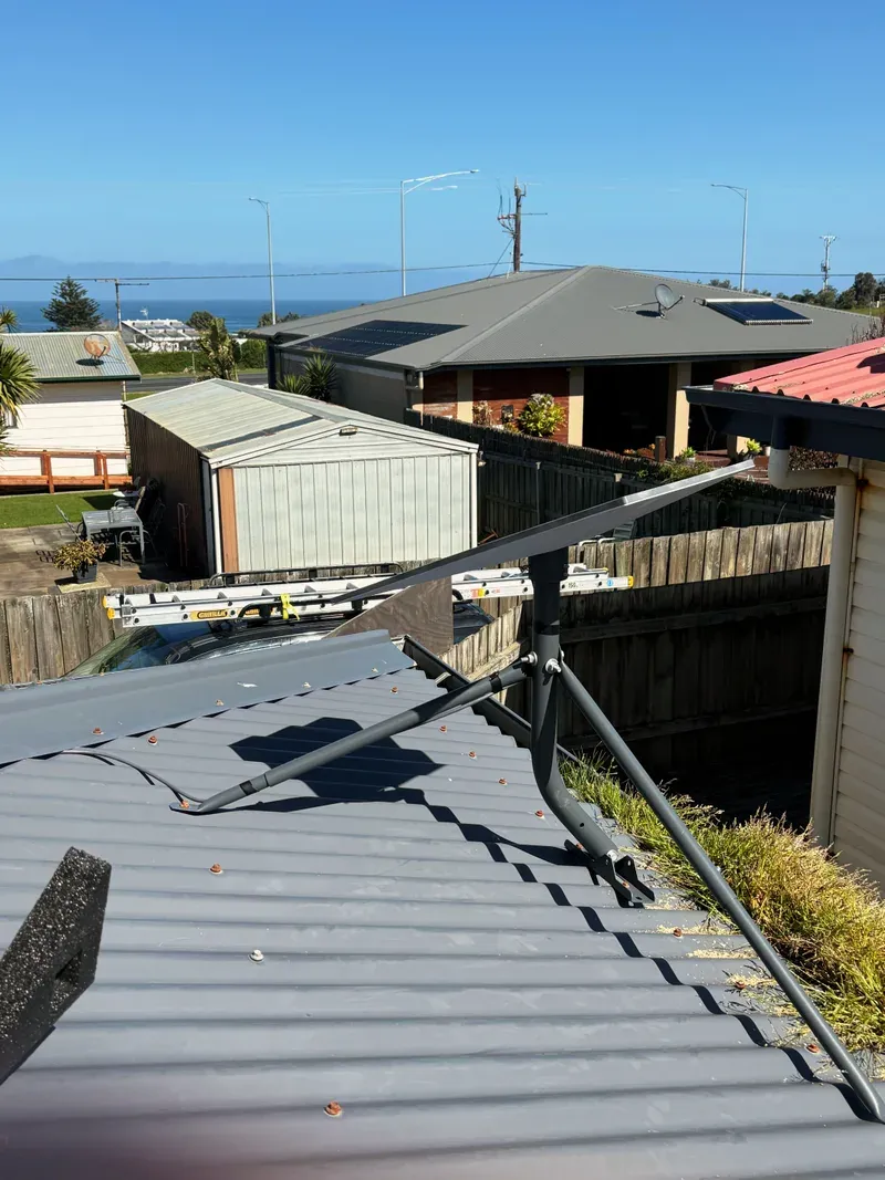 Starlink Standard dish on a tripod on a metal roof in Kilcunda