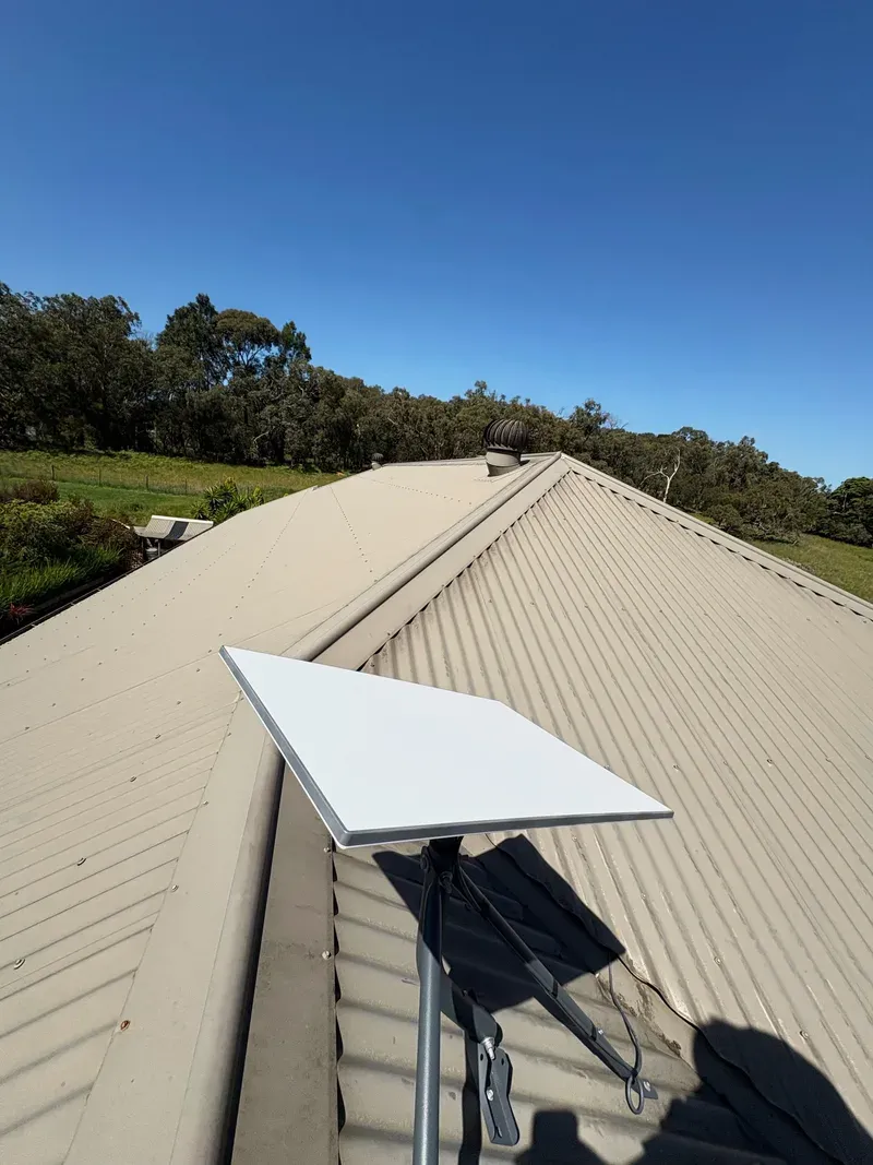 Starlink Standard dish on a tripod on a Colorbond roof in Maryknoll