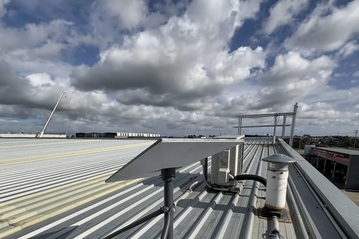 Starlink tripod mounted on the Pakenham factory metal roof.