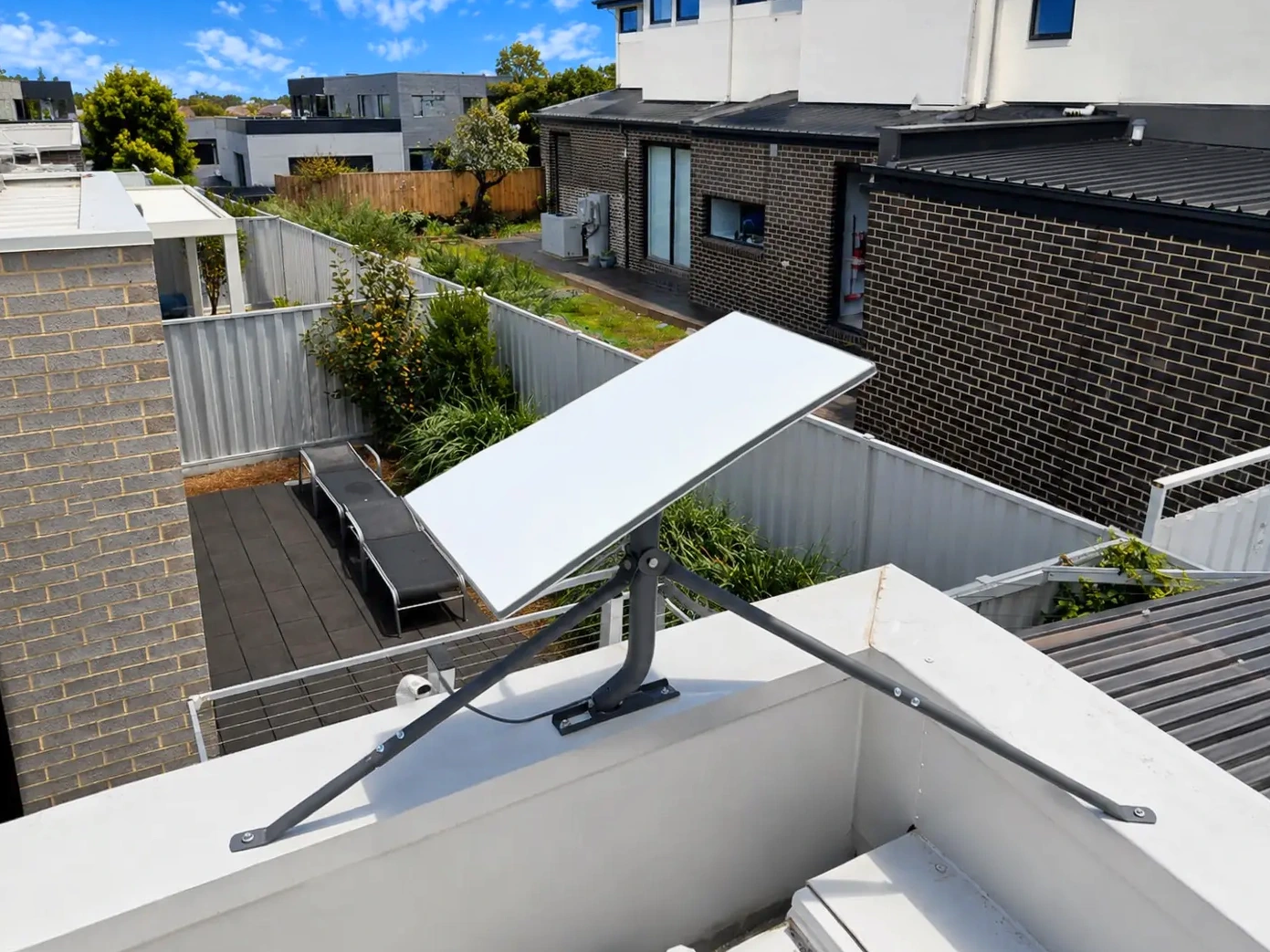Starlink tripod on the Safety Beach flat roof parapet.